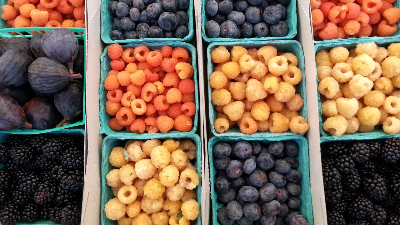 Punnets of berries at a farmer's market.